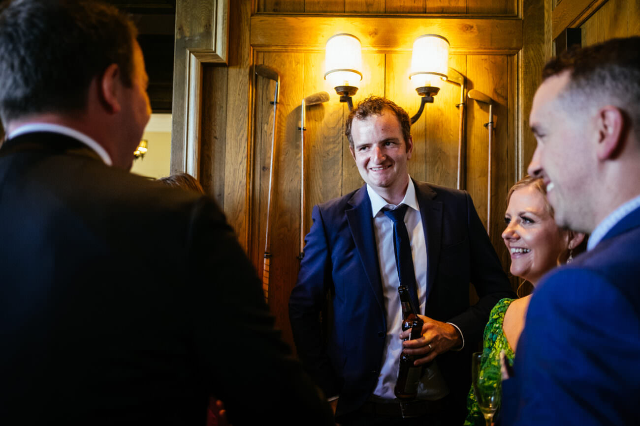 A man in a suit is talking to a woman in a suit at the Wedding at Trump International Hotel Doonbeg.