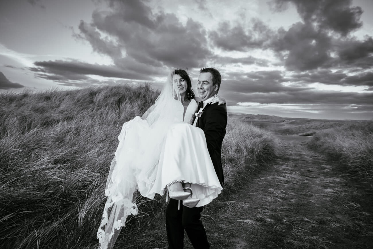 groom carrying bride at Trump International Hotel Doonbeg Wedding