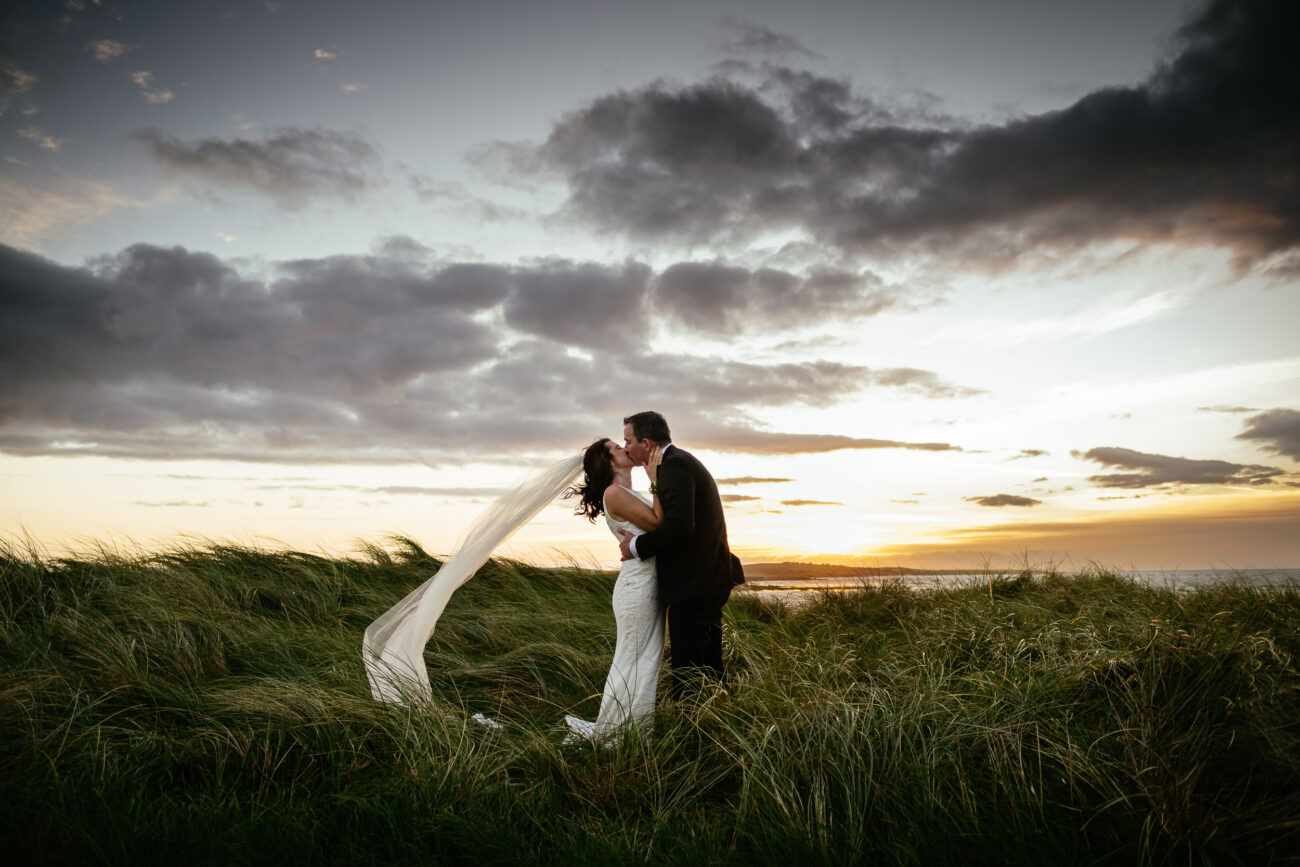 bride and groom at sunset during their Wedding at Trump International Hotel Doonbeg