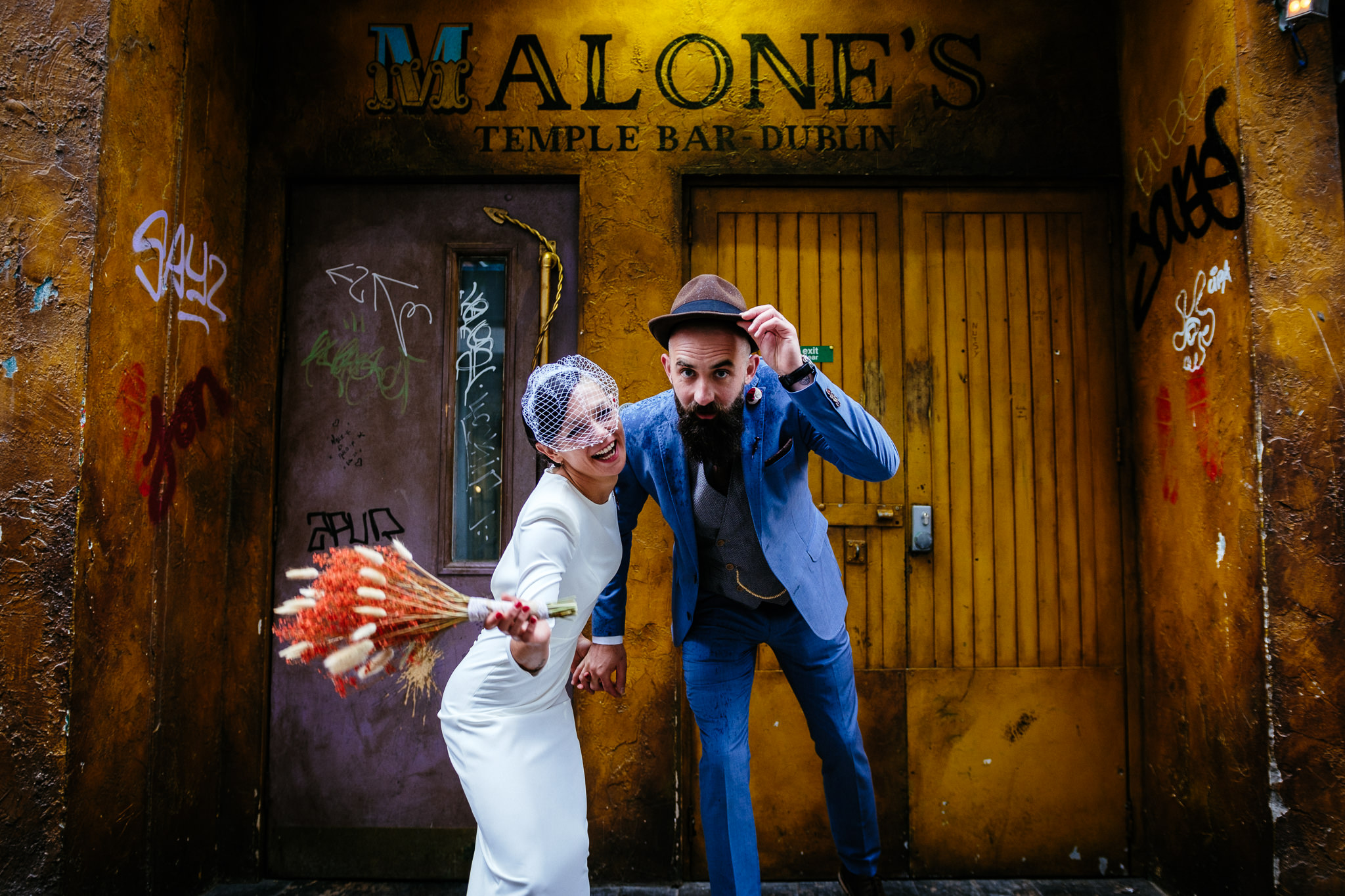 bride and groom laughing in doorway in dublin city