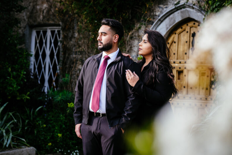 A man and woman standing in front of a door.