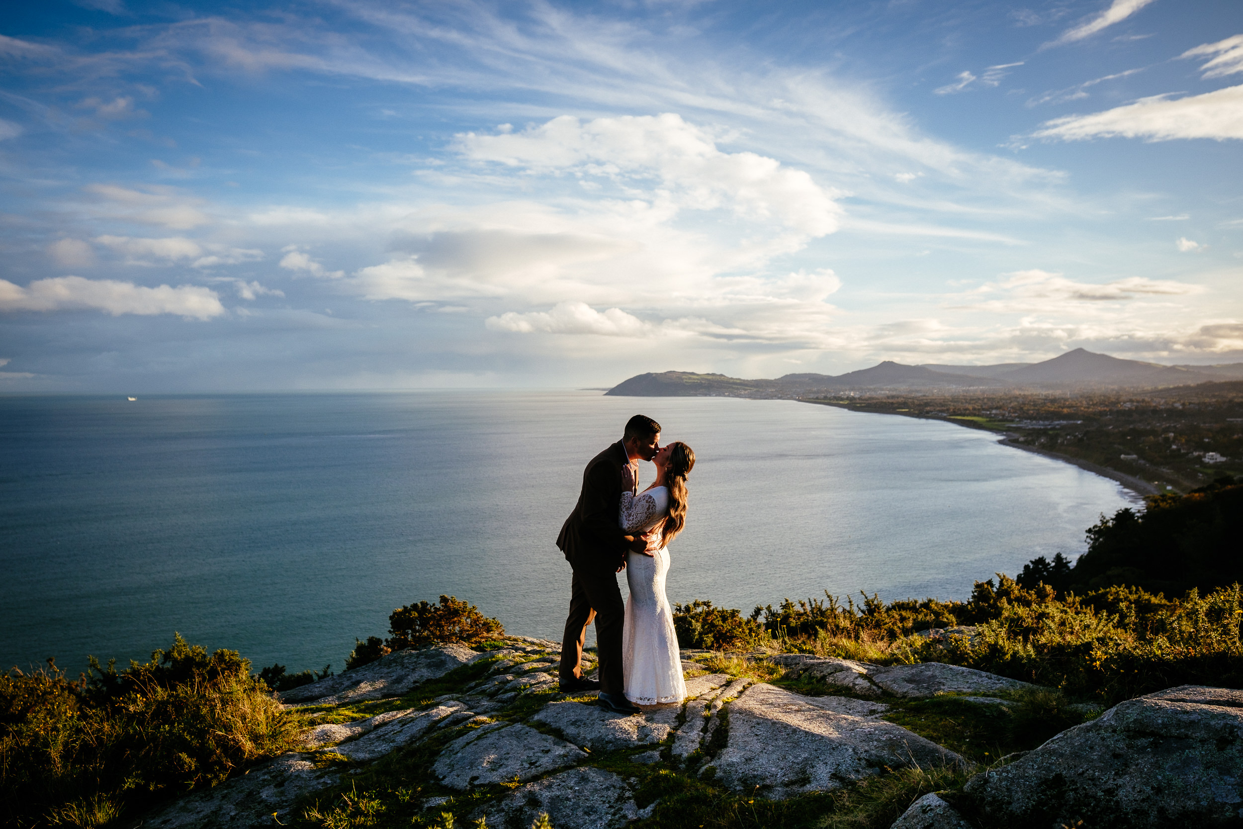 engaged couple walking up killiney hill at sunset